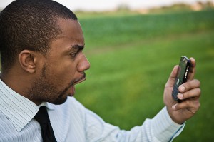 angry guy holding cell phone