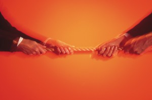 hands-blurred-tug-of-war